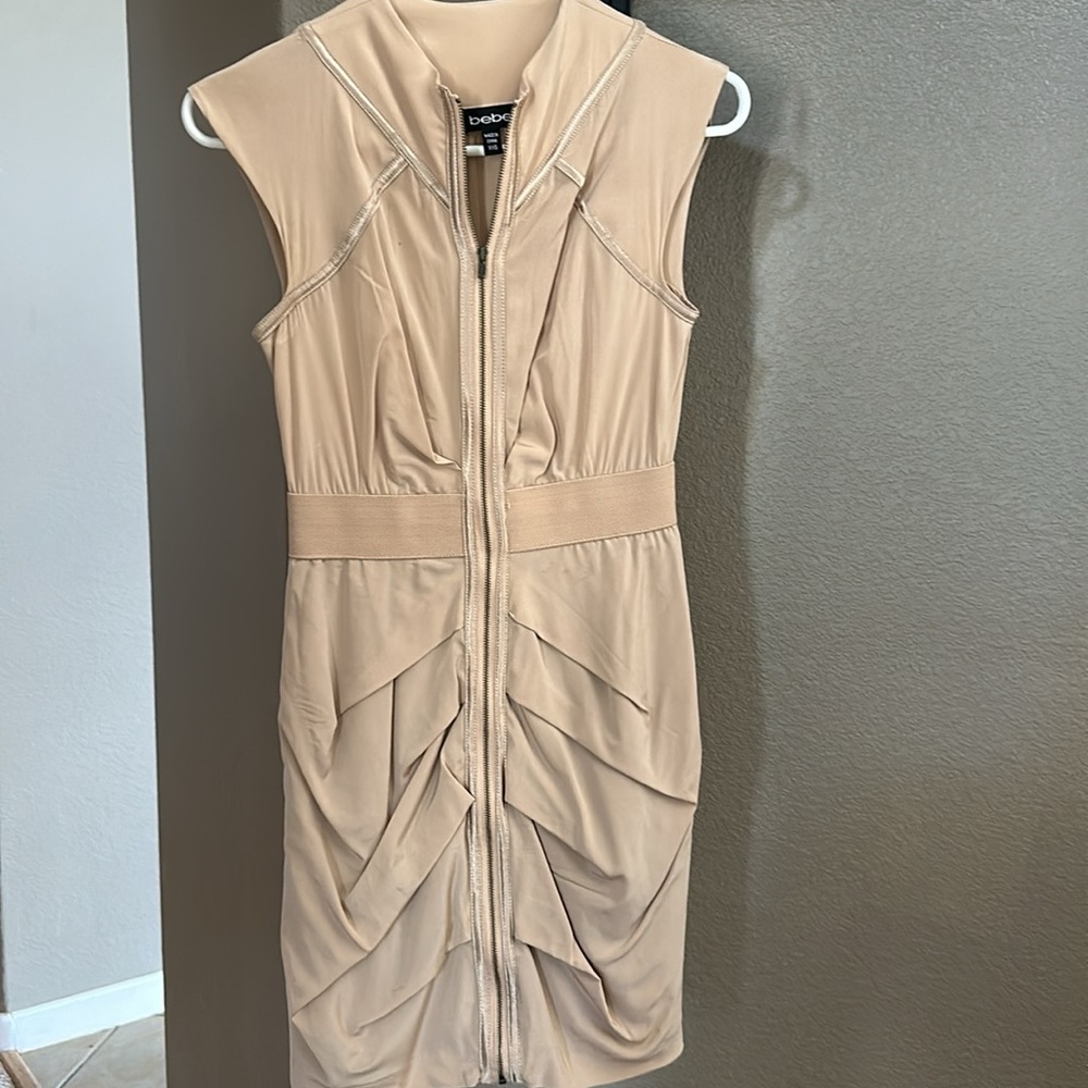 Bebe dress nude/tan color. Full front zipper. Form fitting, super sexy!